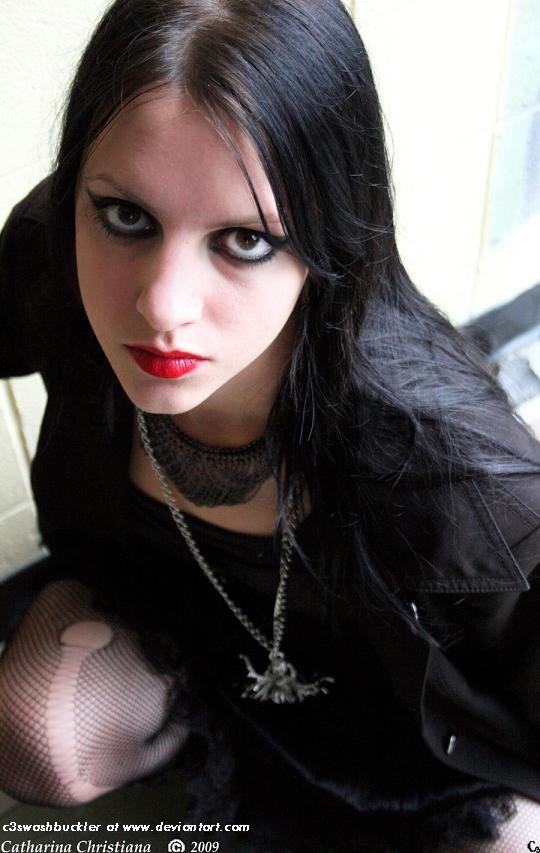A Gothic girl with a simple Gothichaircut and bold lipstick
