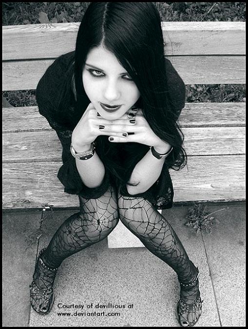 A Gothic-girl sitting on a bench